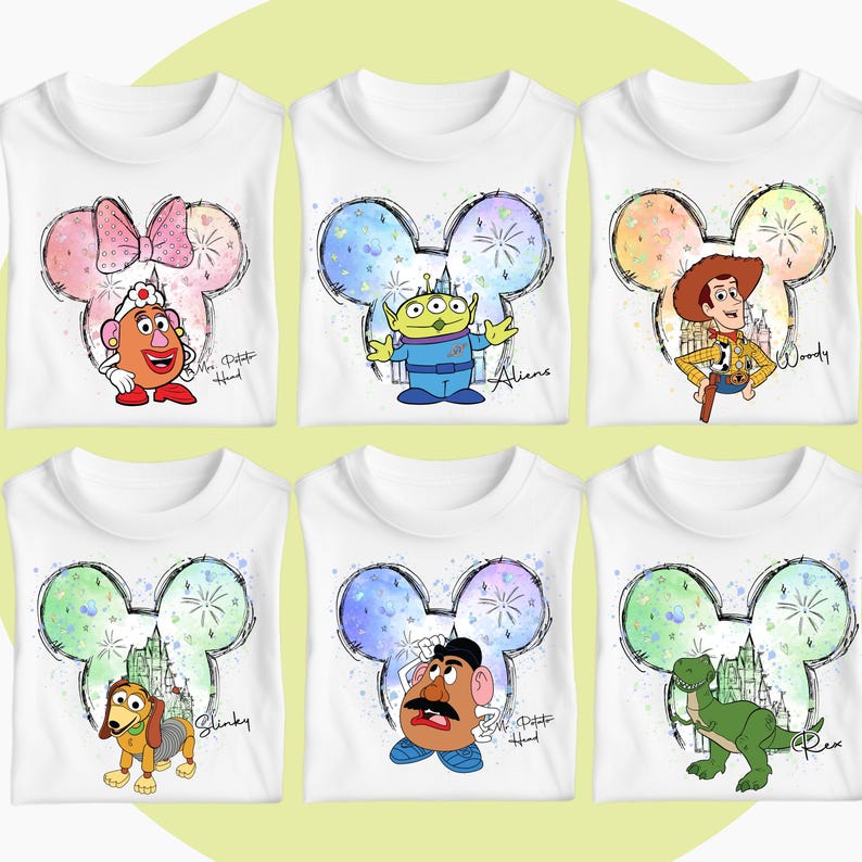 May include: Six white t-shirts with a colorful Mickey Mouse head design featuring different Disney characters. The characters include Mr. Potato Head, Alien, Woody, Slinky Dog, Mr. Potato Head, and Rex.