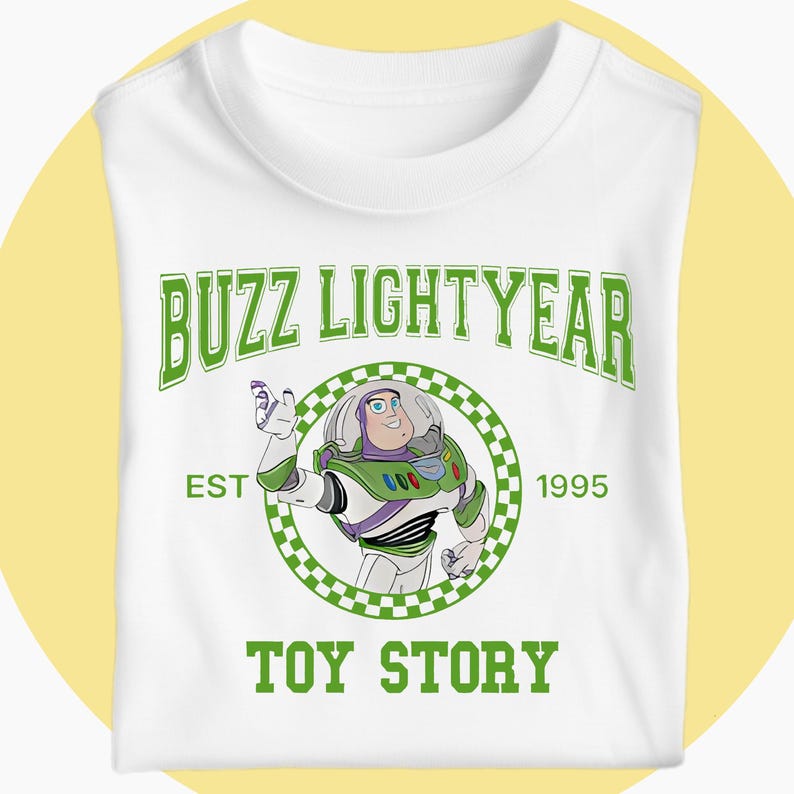 May include: White t-shirt with a green graphic of Buzz Lightyear from Toy Story. The design includes the text "BUZZ LIGHTYEAR", a circular image of the character, and the text "EST 1995" and "TOY STORY".