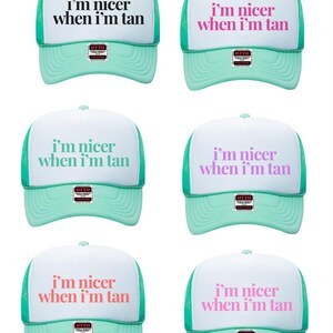 May include: Six trucker hats with white front panels and mint green mesh backs and brims. Each hat features the text "i'm nicer when i'm tan" in various colors including black, pink, mint, purple, coral, and light pink, with an Otto brand sticker.