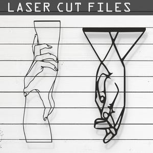 May include: Two black line art designs of hands, one reaching up and the other reaching down. The designs are on a white wood background. The file formats available are CDR, AI, SVG, DXF, and PDF.
