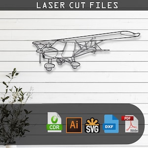 May include: A black line art illustration of a small propeller airplane centered on the page. The text LASER CUT FILES appears at the top. Below the airplane are five file format icons: CDR, Ai, SVG, DXF, and PDF, representing digital design assets.