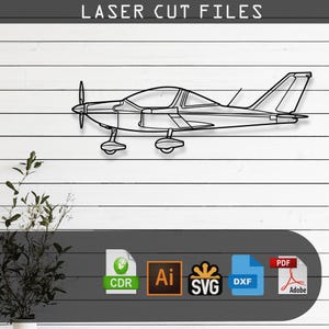 May include: A black line art silhouette of a single-engine propeller airplane. The image includes the text LASER CUT FILES at the top and icons for CDR, Ai, SVG, DXF, and PDF file formats at the bottom, indicating a digital download product.