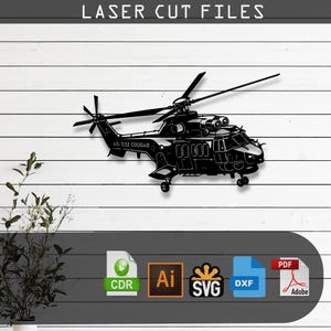 May include: A black silhouette of an AS-532 Cougar helicopter laser cut file design. The text LASER CUT FILES appears at the top. Below the helicopter are icons for CDR, Ai, SVG, DXF, and PDF file formats on a dark gray horizontal banner.