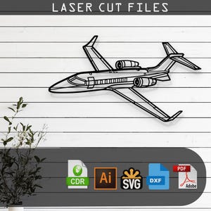 May include: Black metal laser cut file of a jet airplane. The image shows a detailed outline of the aircraft, including wings, engines, and tail. The text "LASER CUT FILES" is at the top. Below the jet are icons for CDR, AI, SVG, DXF, and PDF file formats.