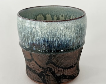 Rustic Cup - wood grain pattern on bare clay with blue-green drips over a cream interior