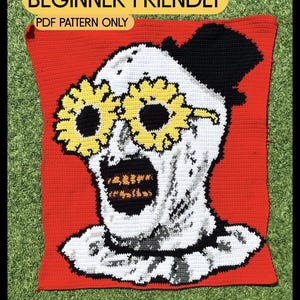 May include: A rectangular crochet tapestry featuring a white skull-like figure with a black top hat, yellow sunflower-shaped glasses, and a dark mouth with gold teeth, set against a solid red background. Text reads BEGINNER FRIENDLY PDF PATTERN ONLY.