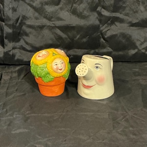 May include: A set of three ceramic mugs with a speckled, matte finish. The mugs are in shades of cream, light gray, and dark gray. Each mug has a simple, minimalist design, perfect for coffee or tea.