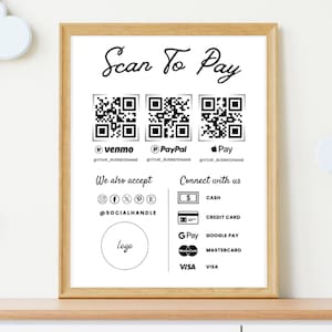 May include: A white sign with black text and graphics that says "Scan To Pay". It includes QR codes for Venmo, PayPal, and Apple Pay. It also lists other payment methods including cash, credit card, Google Pay, Mastercard, and Visa. The sign also includes social media icons and the text "@SOCIALHANDLE".