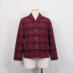 May include: A red and black plaid blazer with a collared neckline and three buttons. The blazer has two front pockets and long sleeves. The jacket is displayed on a mannequin.
