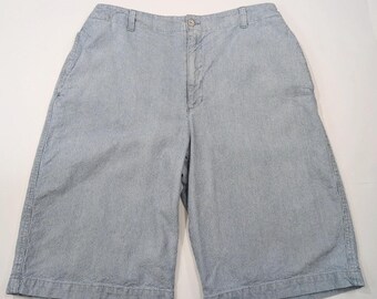 May include: A pair of light blue striped shorts with a button and zipper closure.