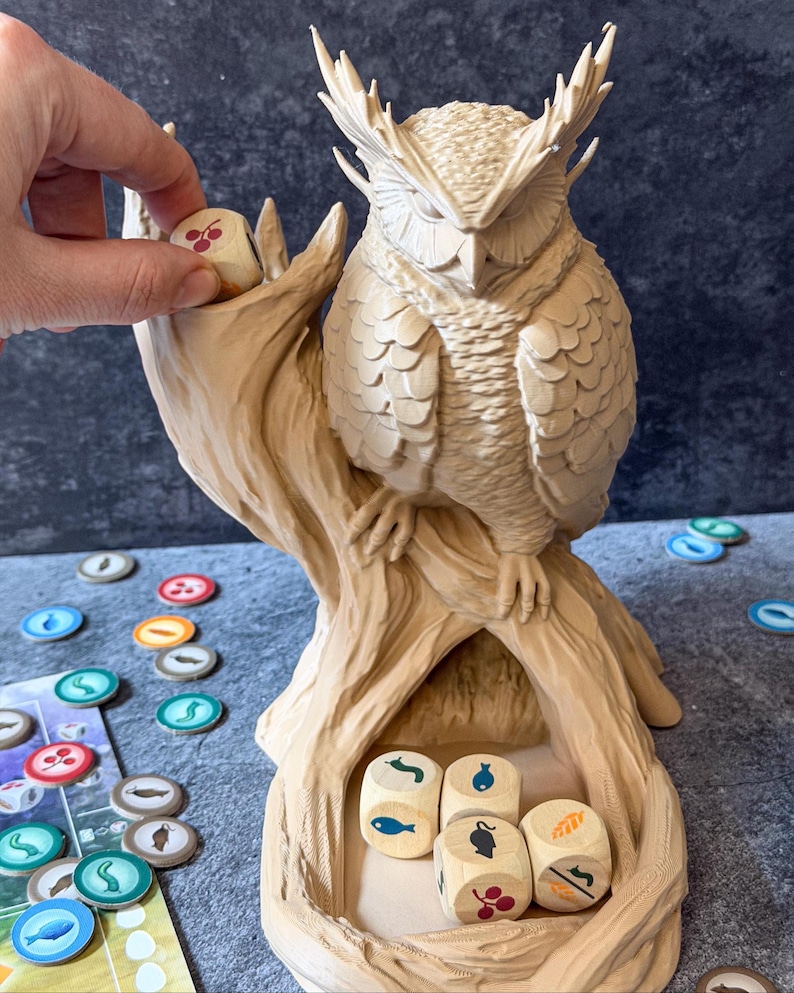 Owl dice tower with Wingspan food dice being placed in dice tower, board game accessory