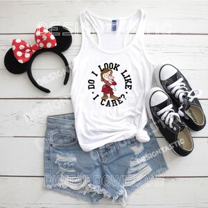 May include: White vest top featuring a cartoon character graphic and the text "I DO I LOOK LIKE CARE?". The image also shows denim shorts, black trainers, and a Minnie Mouse ear headband with a red and white polka dot bow.