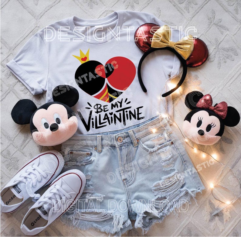 Pu&ograve; includere: Maglietta bianca con un design a forma di cuore rosso e nero e il testo "Be My Villaintine". Sono anche raffigurati un paio di orecchie di Topolino rosse e dorate, un peluche di Topolino e un peluche di Minnie Mouse.