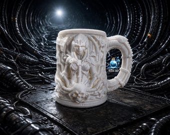 May include: A white ceramic mug with a detailed relief sculpture of a humanoid figure with a skull and tentacles. The mug has a unique handle design and the text "EDJ.3D" is visible. The background is a dark, industrial setting.