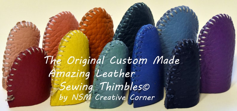 May include: A collection of 10 leather sewing thimbles in various colors, including red, pink, orange, yellow, blue, and purple. The thimbles are all handmade and have a white stitching detail around the top edge. The text "The Original Custom Made Amazing Leather Sewing Thimbles&reg; by NSM Creative Corner" is displayed below the thimbles.