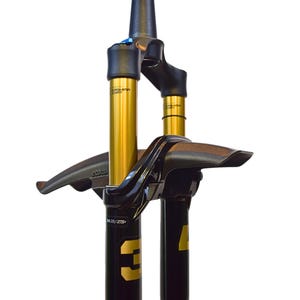 May include: A white ceramic mug with a black handle and the text "But First, Coffee" in a bold, black font. The mug is set against a blurred background, suggesting a cozy setting. The mug appears to be approximately 4 inches tall.