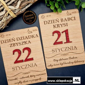 May include: Two wooden plaques with engraved text and red numbers. One says "Dzień Babci Krysi 21 Stycznia" and the other says "Dzień Dziadka Zbyszk 22 Stycznia". Both have decorative elements and the words "Handmade With Love".