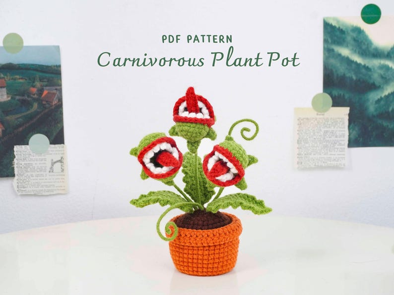 May include: A crocheted carnivorous plant pot with three open-mouthed flower heads in green, red, and white, set in an orange pot. The text "PDF PATTERN Carnivorous Plant Pot" is above the plant. The plant has green leaves and brown soil.