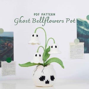 May include: A crocheted Ghost Bellflowers Pot, a whimsical Halloween decoration. The white pot has a skull design, and the plant features white ghost-shaped flowers with black eyes and green stems and leaves. The text "PDF PATTERN Ghost Bellflowers Pot" is visible.