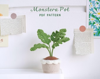May include: A crocheted Monstera plant in a beige pot with a white rim. The plant has green leaves and is sitting on a white surface. The text "Monstera Pot PDF PATTERN" is written above the plant.