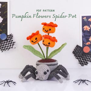 May include: A crochet PDF pattern titled Pumpkin Flowers Spider Pot featuring three orange pumpkin-shaped flowers with jack-o'-lantern faces on green stems, planted in a gray spider-shaped pot with eight dark gray legs and black eyes.