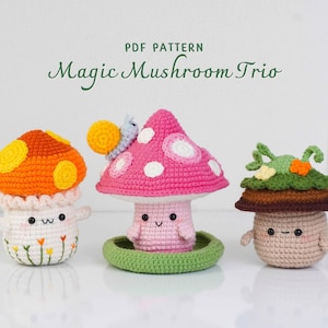 May include: Three crocheted mushroom figures in orange, pink, and brown with smiling faces. The orange mushroom has yellow spots, the pink one has white spots and a snail, and the brown one has green leaves. The text "PDF PATTERN Magic Mushroom Trio" is at the top.