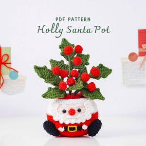 May include: A crocheted Santa Claus pot with a holly plant. The Santa pot is red and white with black boots and a gold buckle. The holly plant has green leaves and red berries. The text "PDF PATTERN Holly Santa Pot" is at the top.