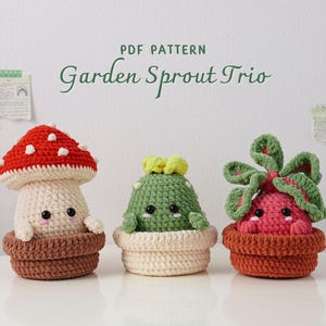 May include: Three crocheted garden sprouts: a mushroom with a red cap and white spots, a green cactus, and a pink sprout with green leaves. Each is in a brown or cream-colored pot. The text "PDF PATTERN Garden Sprout Trio" is at the top.
