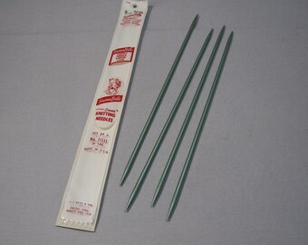 May include: A set of four green knitting needles in a white package labeled "Susan Bates" with the text "Knitting Needles No. 11/11 or 18/2 Made in USA".