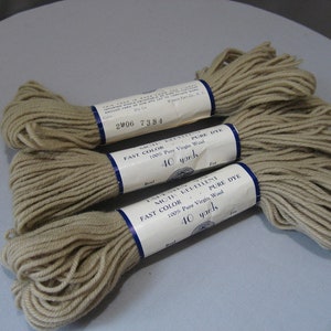 May include: Three skeins of beige wool yarn, each labeled "Moth Repellent Fast Color Pure Dye 100% Pure Virgin Wool 40 yards".