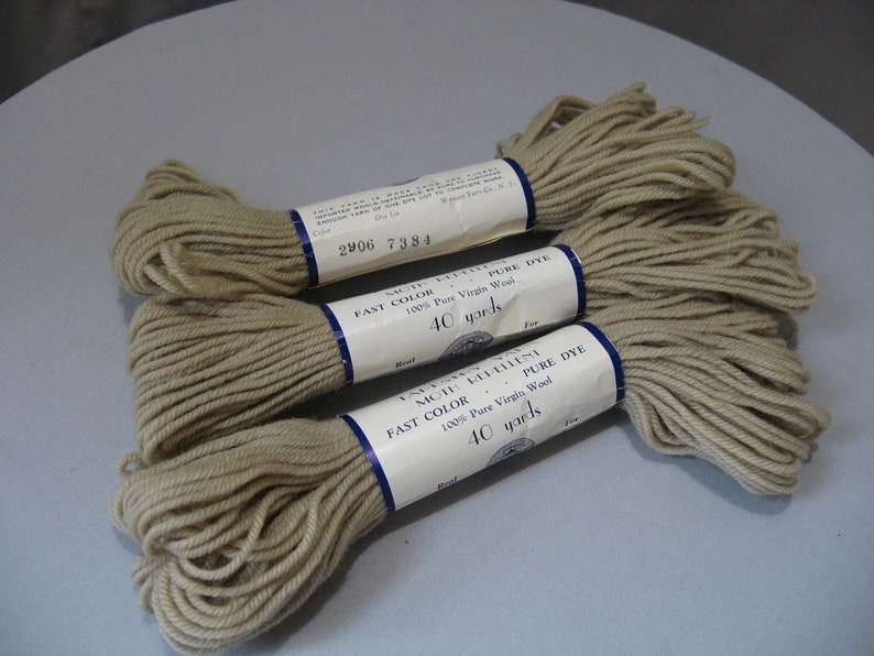 May include: Three skeins of beige wool yarn, each labeled "Moth Repellent Fast Color Pure Dye 100% Pure Virgin Wool 40 yards".