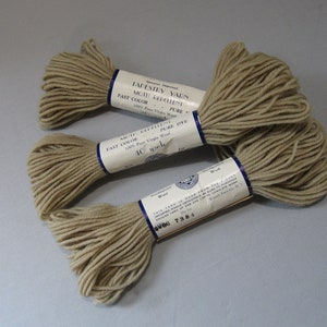 May include: Three skeins of beige tapestry yarn, each labeled "Genuine Imported Tapestry Yarn Moth Repellent Fast Color Pure 100% Pure Virgin Wool Pure Dye 40 yards".