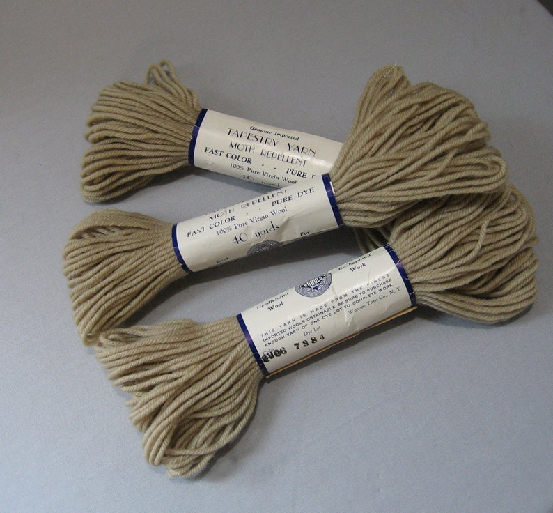May include: Three skeins of beige tapestry yarn, each labeled "Genuine Imported Tapestry Yarn Moth Repellent Fast Color Pure 100% Pure Virgin Wool Pure Dye 40 yards".