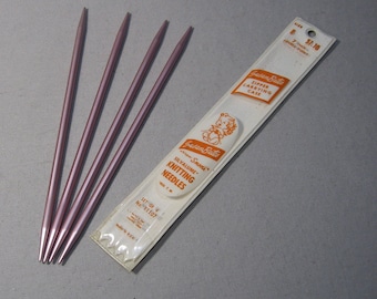 May include: A set of four pink knitting needles in a plastic package. The package is labeled "Silvalume Knitting Needles" and "Set of 4 No. 11107".