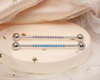 May include: Two surgical steel barbell body jewelry pieces with opal gemstone accents. One barbell has pink opal stones and the other has blue opal stones.