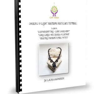 May include: A tutorial booklet for making a macrame necklace with beads. The cover features a close-up of a black macrame necklace with purple beads, resting on two white stones. The title of the booklet is "Shadow & Light Macrame Necklace Tutorial" and the subtitle is "Learn "Leather Knotting - Lark's Head Knot" "Using Large-Hole Beads & Leather" "Creating Macrame Floral Motifs" by Laura Gasparrini.