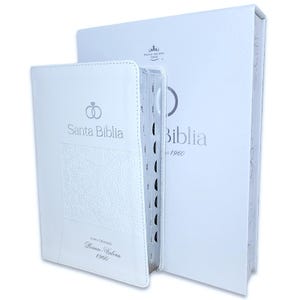 May include: White leather-bound Bible with a silver ring design and the text "Santa Biblia" on the front cover. The spine has the text "Reina Valera 1960".
