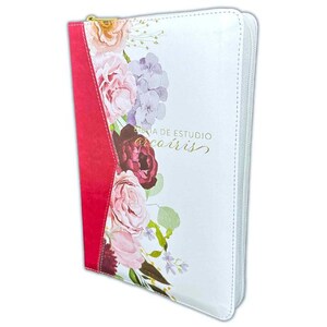 May include: White Bible cover with a floral design featuring pink, purple, and burgundy flowers. The cover has a red spine and a gold zipper. The text "BIBLIA DE ESTUDIO arcoíris" is printed in gold.