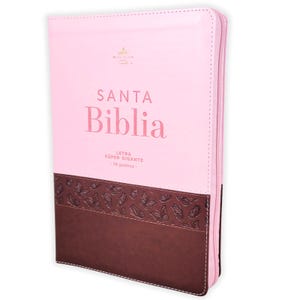May include: A pink and dark brown zippered Bible with a butterfly pattern embossed on the lower brown section. The cover features the text SANTA Biblia and LETRA SÚPER GIGANTE 19 puntos printed in pink on the upper light pink section.