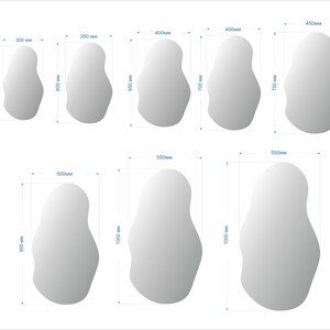 May include: A set of 10 different sized, irregular shaped, white mirrors. The mirrors are all in a white frame and are arranged in two rows. The measurements of each mirror are listed in millimeters.