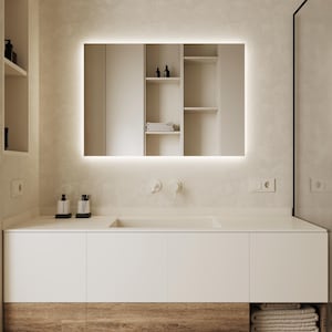 May include: A white bathroom vanity with a white countertop and a single sink. The vanity has two drawers and a wooden base. A mirror with a light around the perimeter is mounted above the sink.