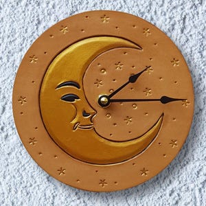 Leather moon clock with a shimmering gold color Crescent Moon and stars, all hand-tooled into the leather