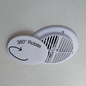 May include: A white air vent with a rotating cover, mounted on a textured, off-white surface. The cover is labeled "360° Rotate" with an arrow indicating the direction of rotation. The vent has a circular design.