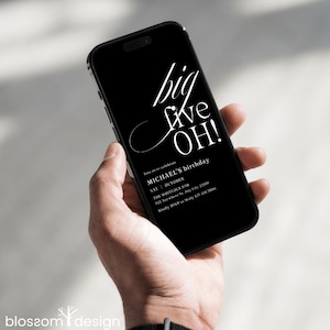 May include: A black smartphone displays a birthday invitation with white text. The invitation reads "big five OH!" and includes details for Michael's birthday celebration at The Whitlock Bar.
