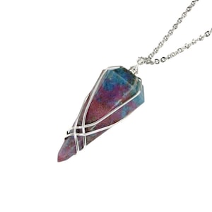 May include: A silver chain necklace with a pink and blue gemstone pendant. The gemstone is wrapped in silver wire.