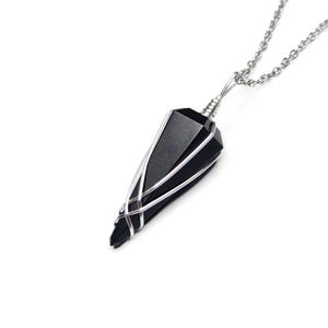May include: A black obsidian point pendant wrapped in silver wire, hanging from a silver chain.