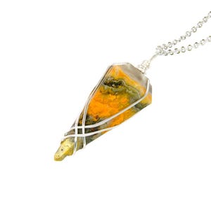 May include: A silver chain necklace with a yellow, orange, and green bumblebee jasper pendant wrapped in silver wire.