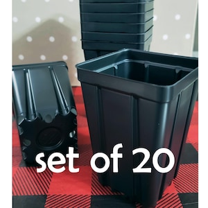 May include: A set of 20 black plastic square plant pots. The pots are stacked in a pile and there is one pot in front of the pile. The text "set of 20" is written in white on a red and black checkered background.