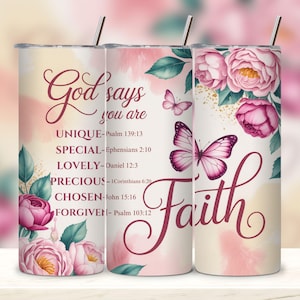May include: A set of three stainless steel tumblers with floral and butterfly designs. The tumblers feature the words "God says you are" and "Faith" in elegant script, along with inspirational verses. The design includes pink roses and butterflies.