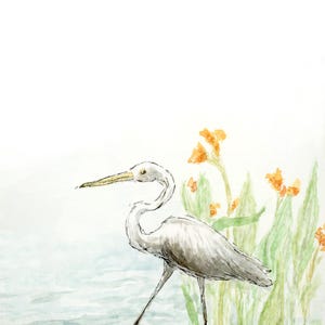 May include: Watercolor painting of a white heron standing near water and orange flowers. The bird has a long neck and beak, with its legs extended. The background is a soft blue and green.
